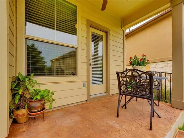a view of a chair and table in the patio