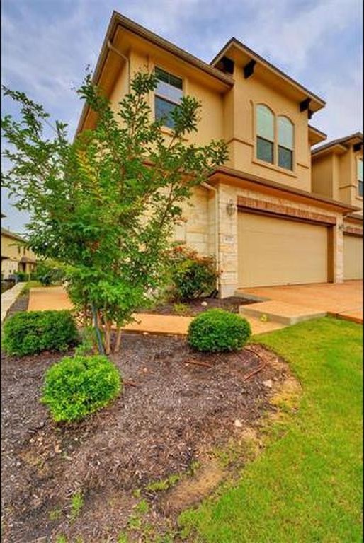 14001 Avery Ranch Boulevard, Unit 401 Austin, TX 78717 - Photo 7 of 29 a front view of a house with garden