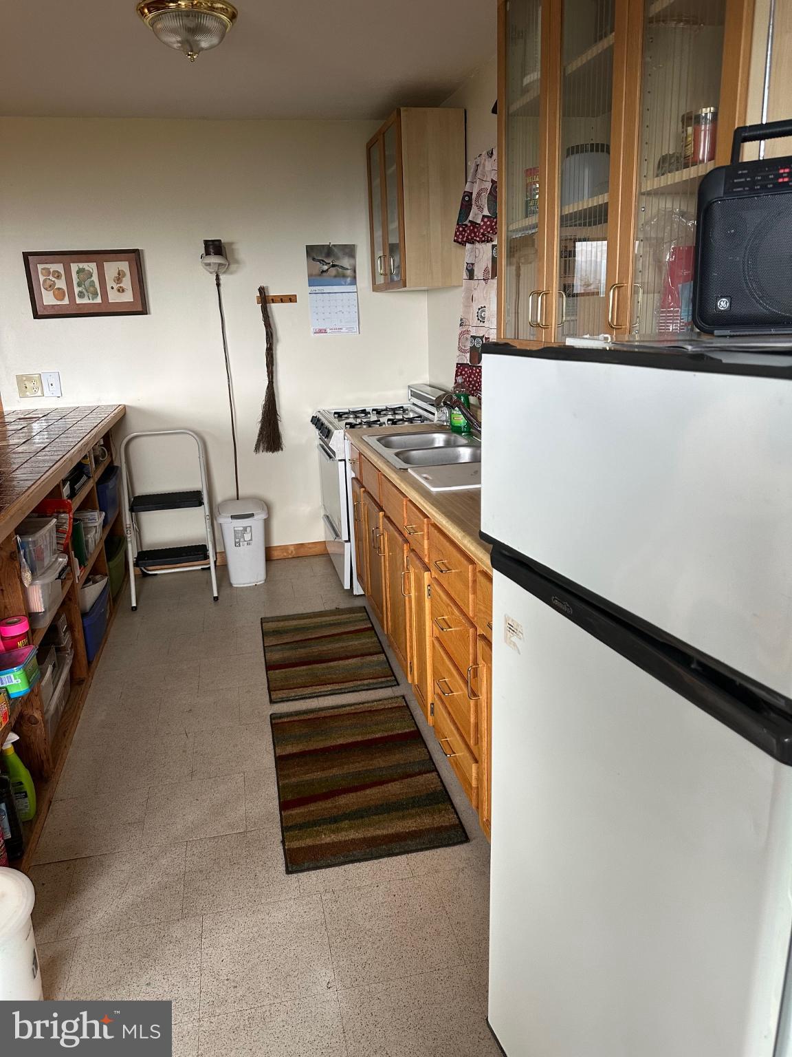 46 Pond Road Franklin, WV 26807 - Photo 12 of 28 a kitchen with granite countertop a refrigerator and a stove top oven