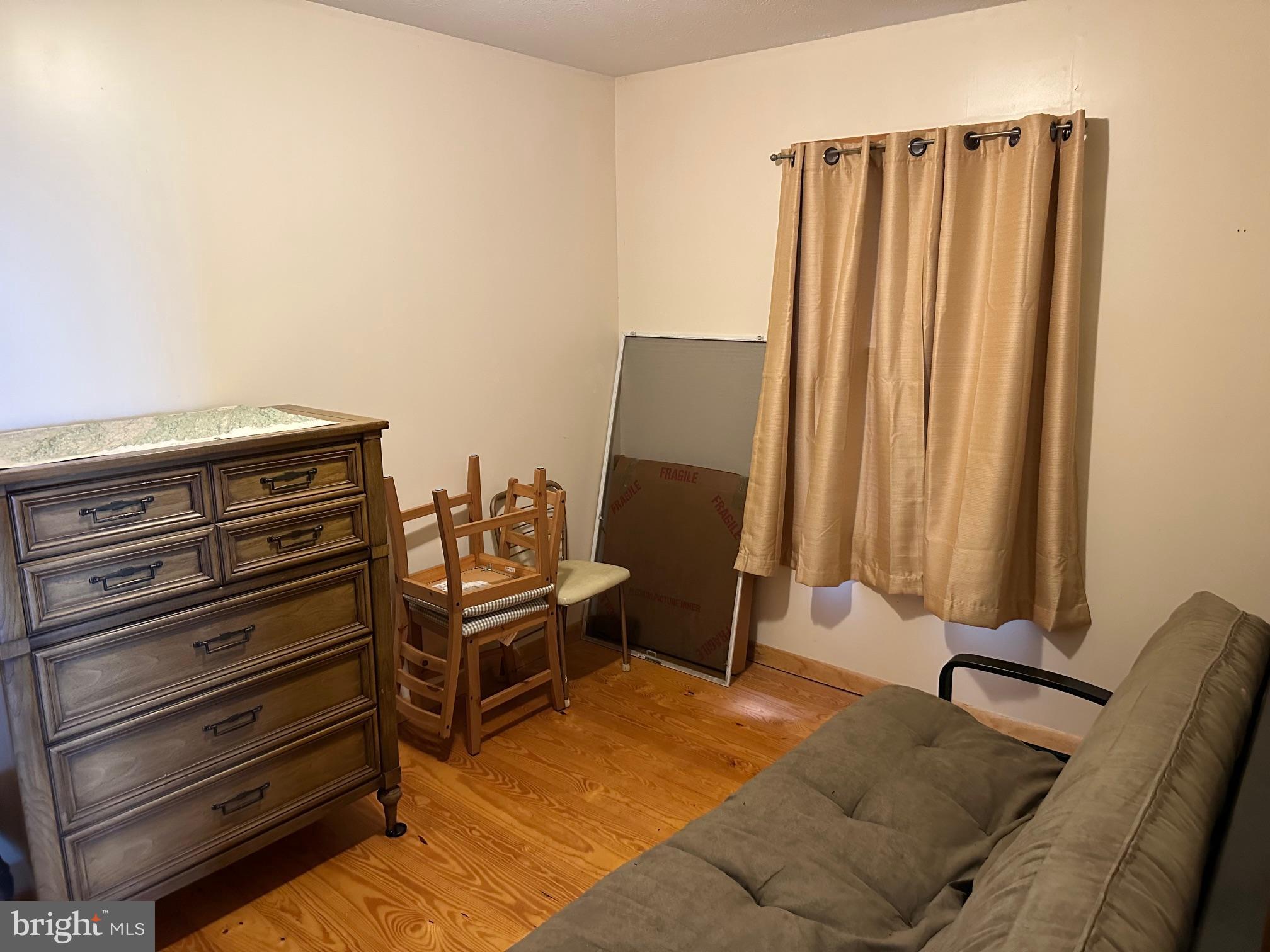 46 Pond Road Franklin, WV 26807 - Photo 15 of 28 a view of a bedroom with furniture and a gate