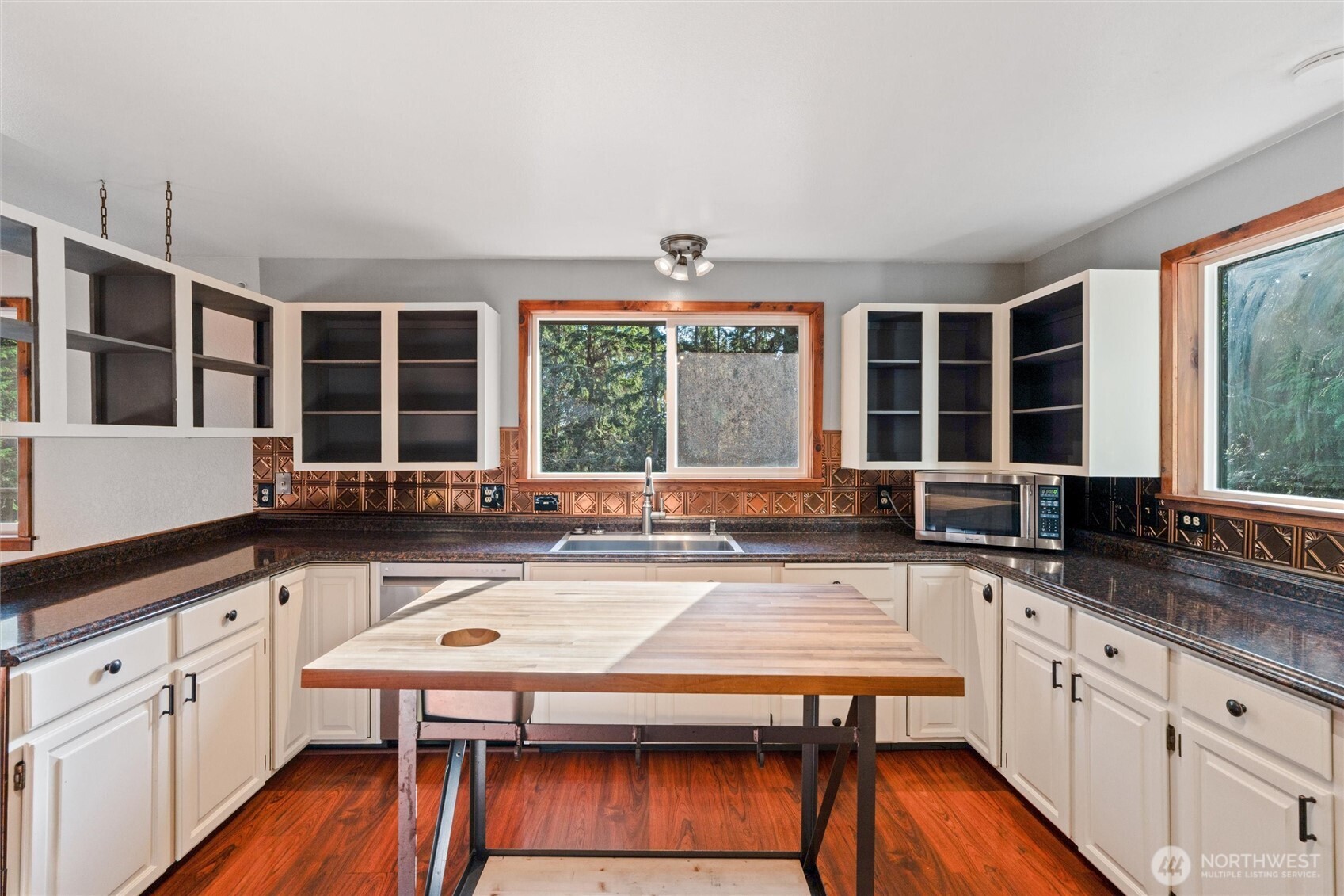155 Blueberry Hill Road Port Ludlow, WA 98365 - Photo 11 of 39 a kitchen with a stove a sink and wooden cabinets