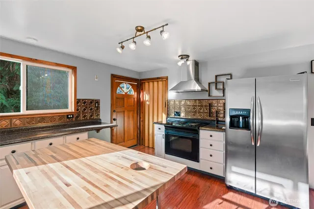 a kitchen with stainless steel appliances a sink stove and refrigerator