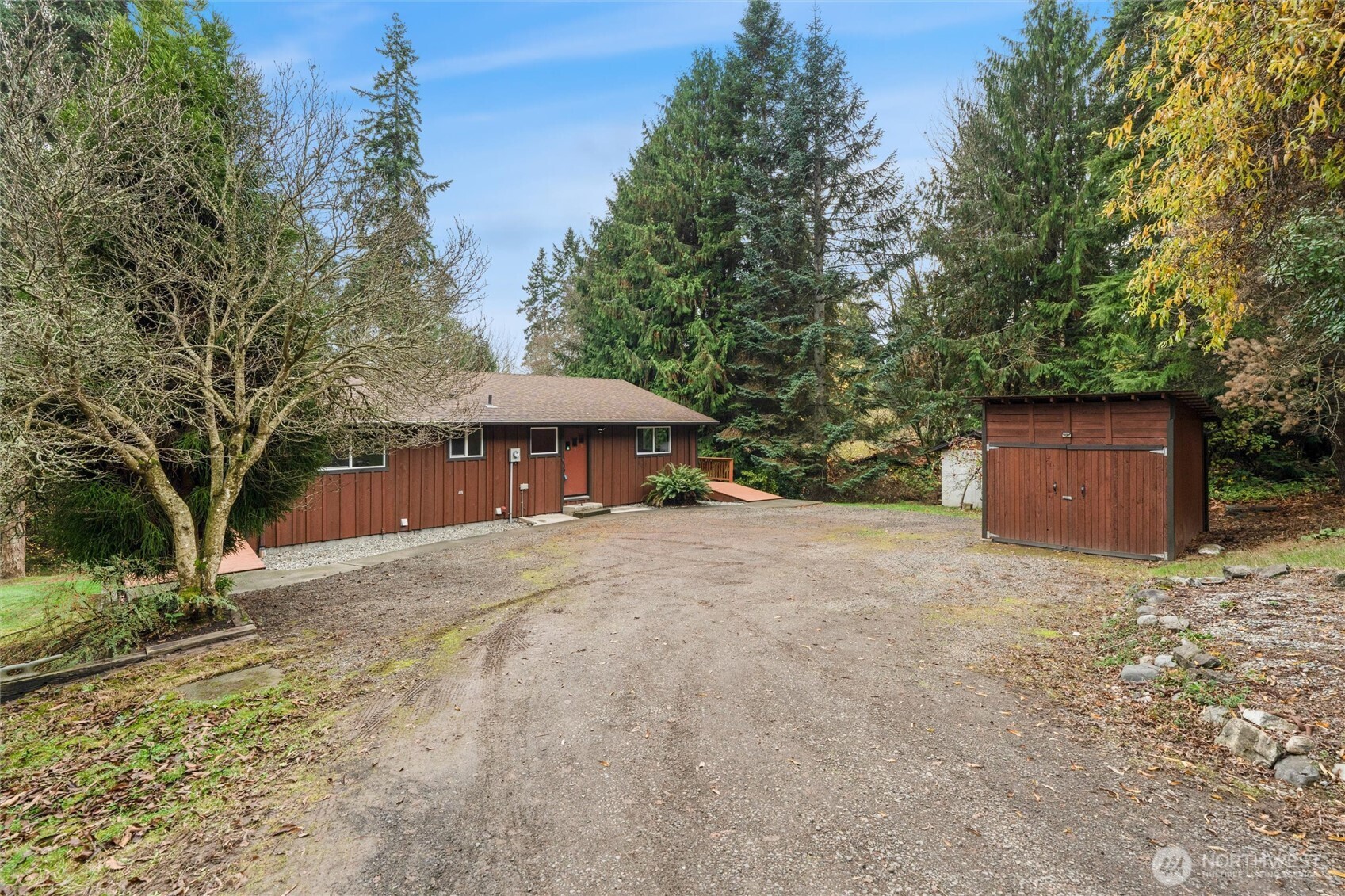 155 Blueberry Hill Road Port Ludlow, WA 98365 - Photo 2 of 39 a front view of a house with yard and trees