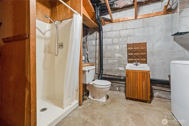a bathroom with a sink a toilet and a shower