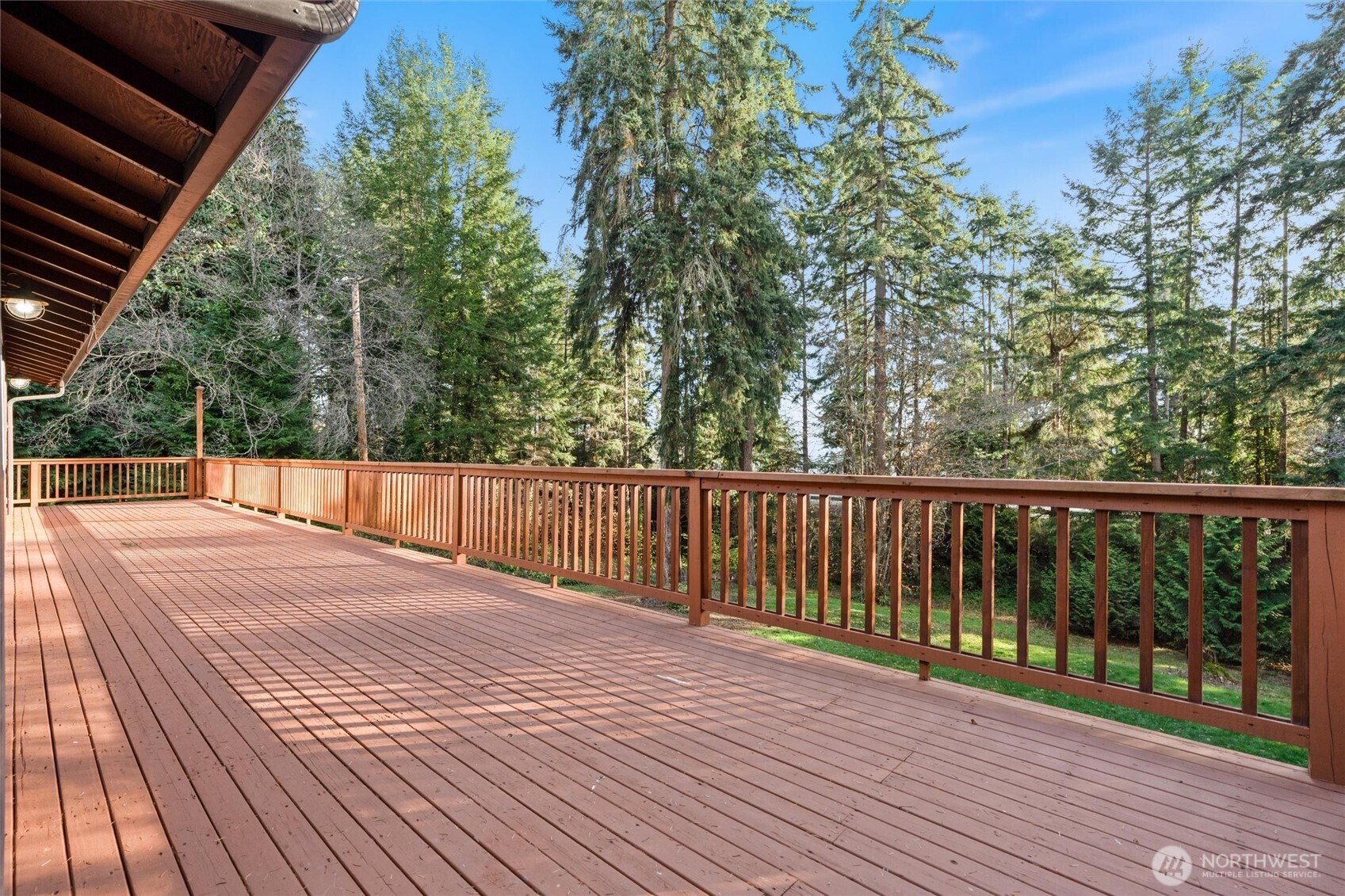 155 Blueberry Hill Road Port Ludlow, WA 98365 - Photo 30 of 39 a view of balcony with wooden floor and outdoor space