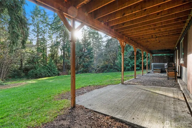 a view of patio with table and chairs with wooden floor and fence