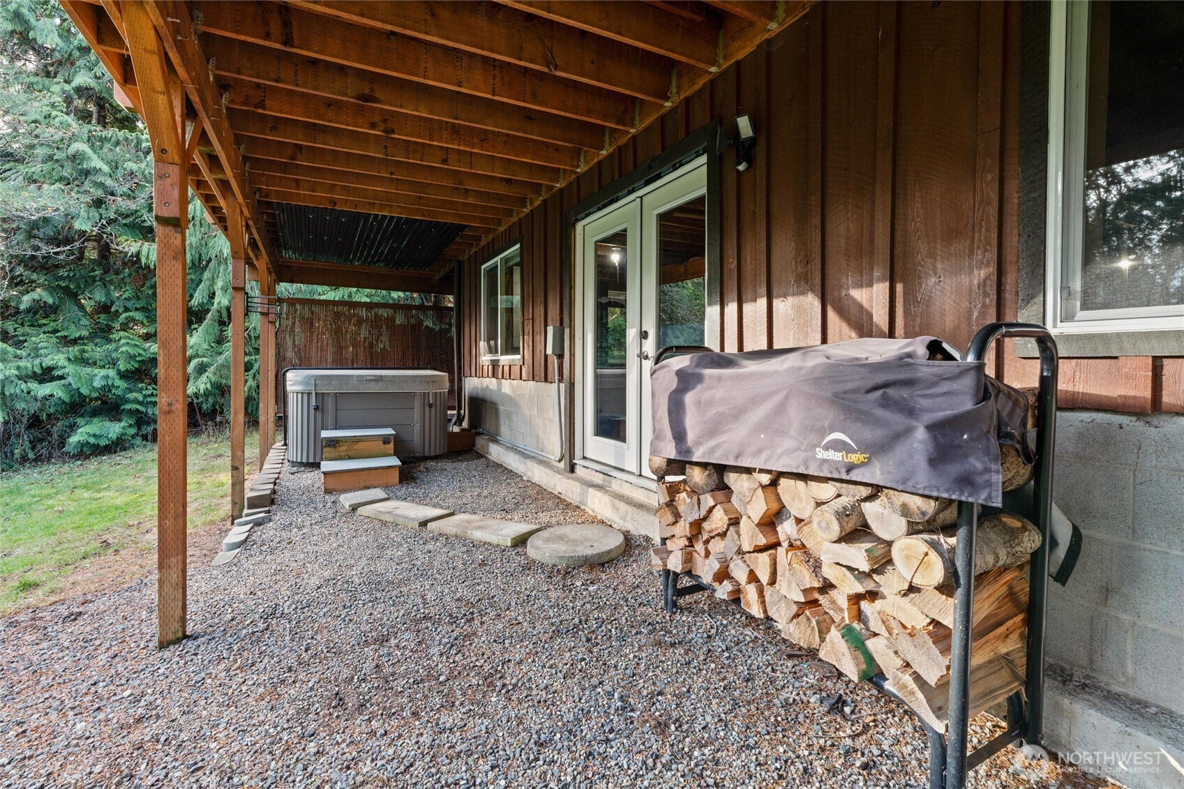 155 Blueberry Hill Road Port Ludlow, WA 98365 - Photo 34 of 39 a view of patio with table and chairs with wooden floor and fence