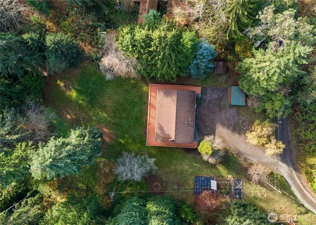 an aerial view of a house with a yard