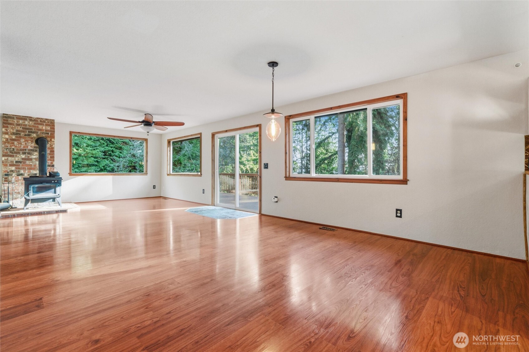 155 Blueberry Hill Road Port Ludlow, WA 98365 - Photo 7 of 39 a view of an empty room with wooden floor and a window