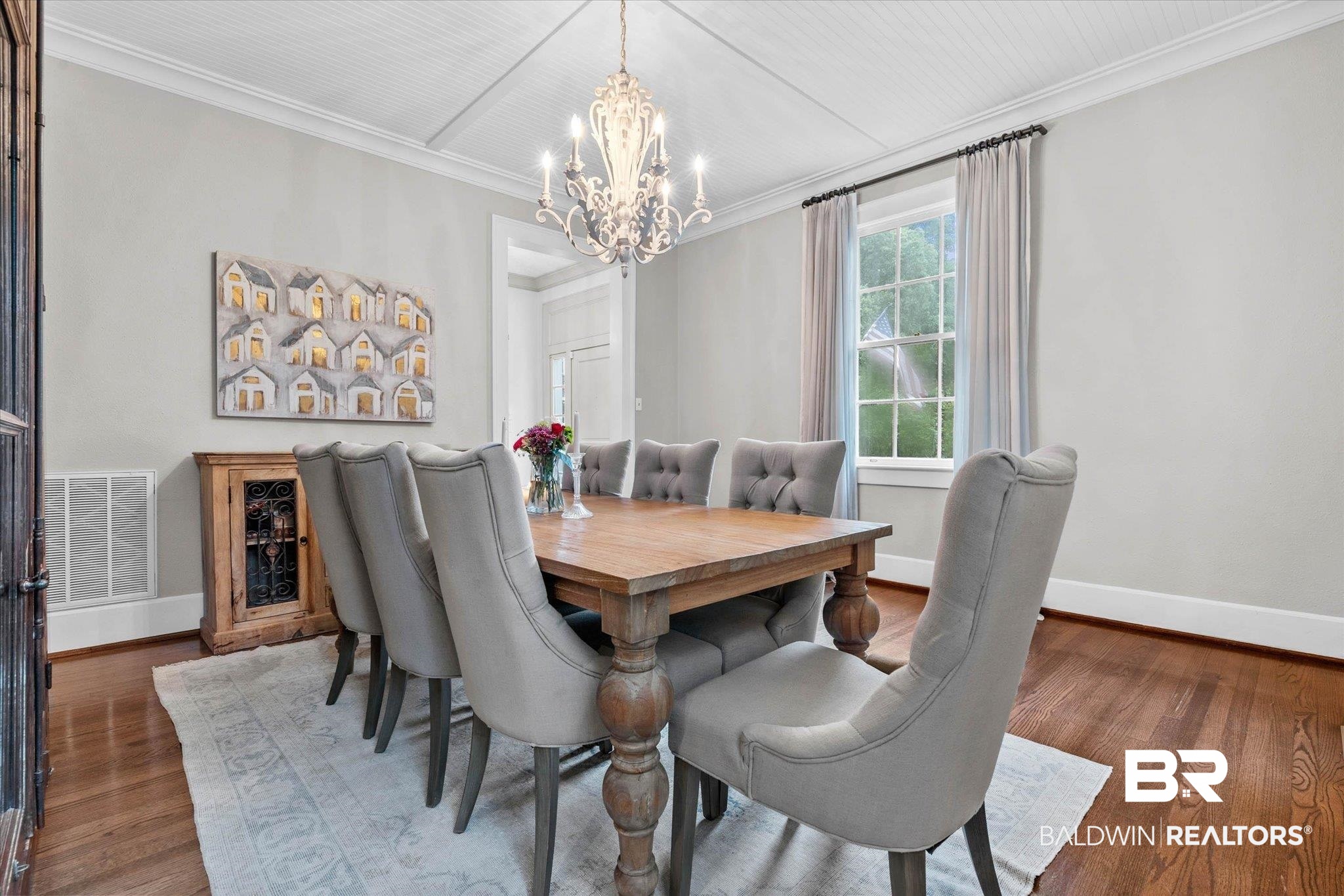 3863 Old Shell Road Mobile, AL 36608 - Photo 18 of 48 Dining area featuring hardwood flooring, a coffered ceiling, crown molding, a chandelier, and a window with natural light