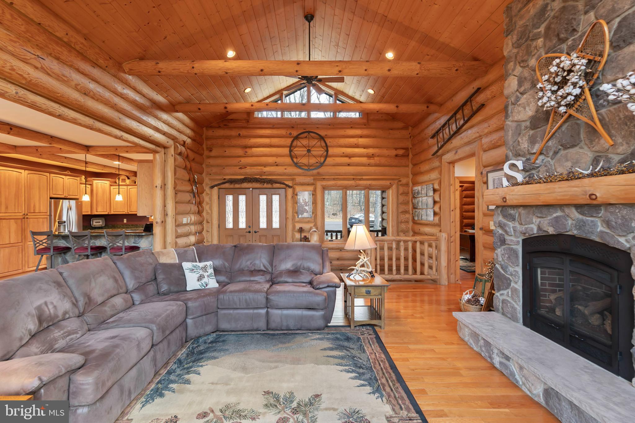 181 Signal Ridge Lane Winchester, VA 22603 - Photo 22 of 70 a living room with furniture a fireplace and a chandelier