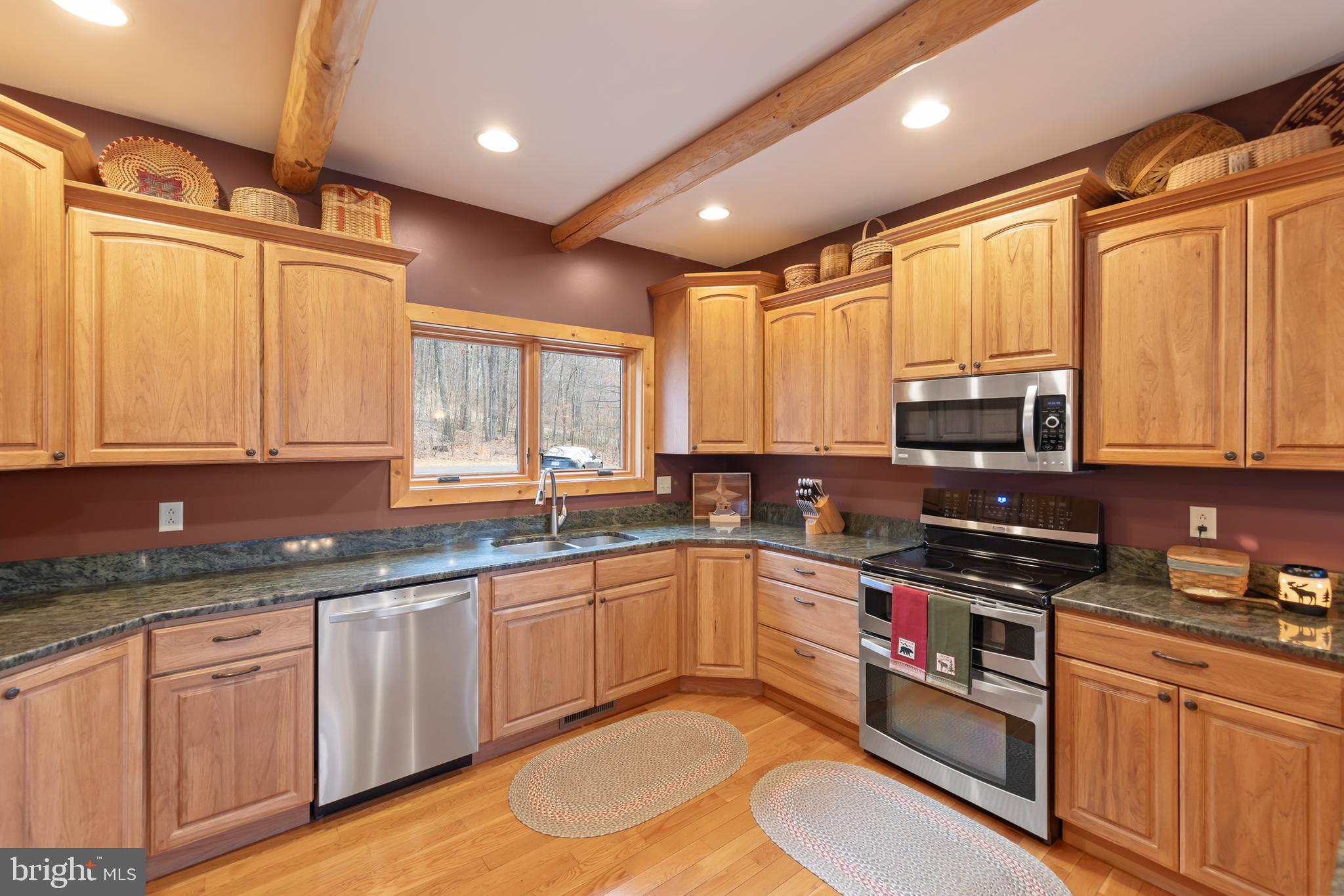 181 Signal Ridge Lane Winchester, VA 22603 - Photo 25 of 70 a kitchen with stainless steel appliances granite countertop a sink stove and microwave