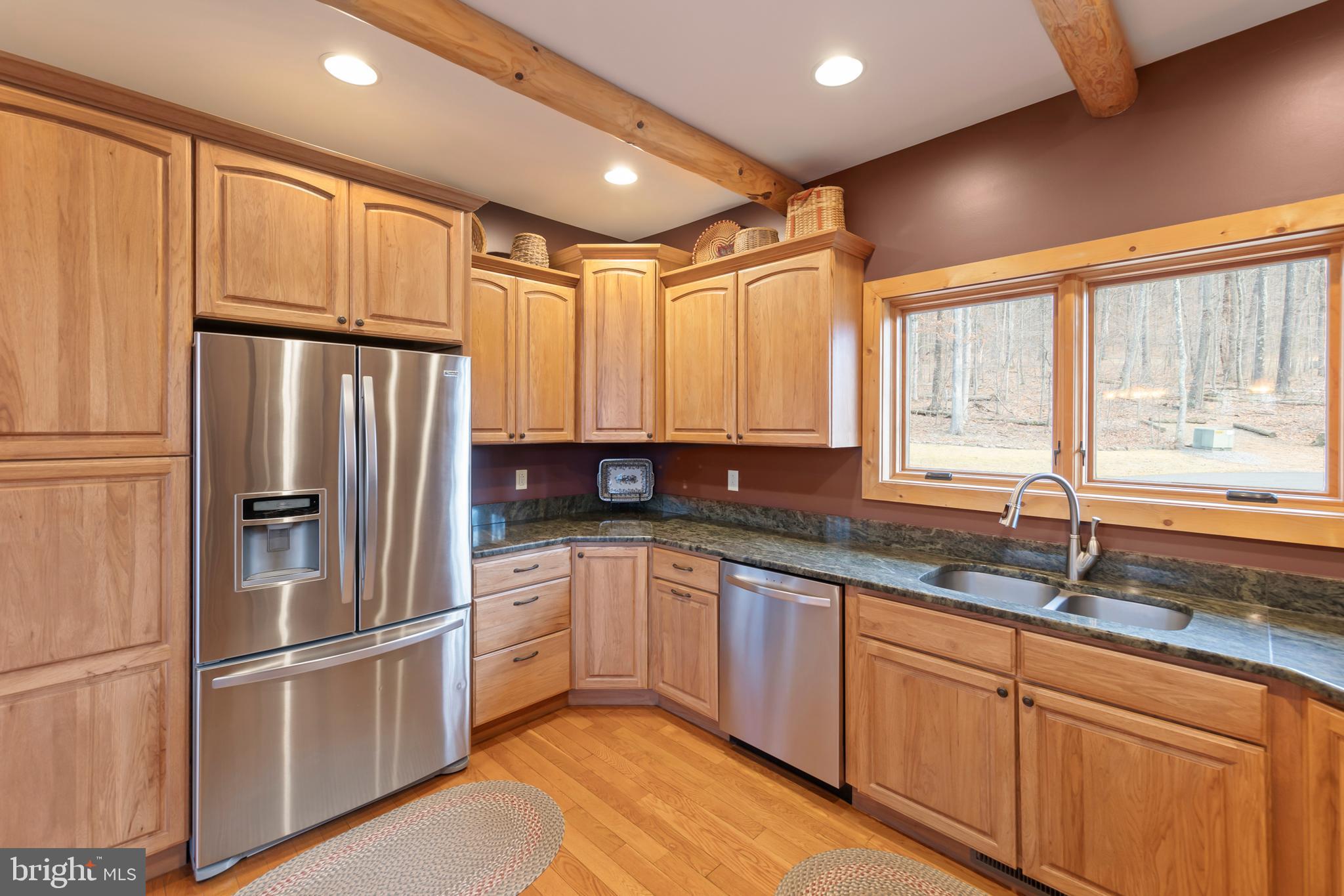 181 Signal Ridge Lane Winchester, VA 22603 - Photo 28 of 70 a kitchen with stainless steel appliances granite countertop a refrigerator sink and cabinets