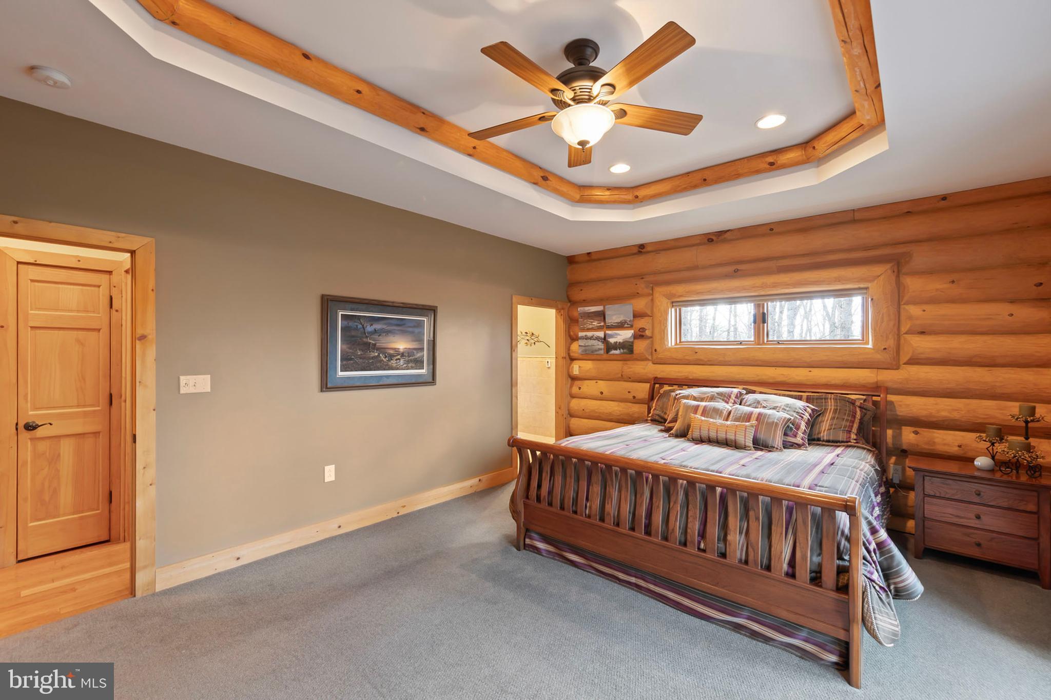 181 Signal Ridge Lane Winchester, VA 22603 - Photo 36 of 70 a bedroom with a bed and a chandelier