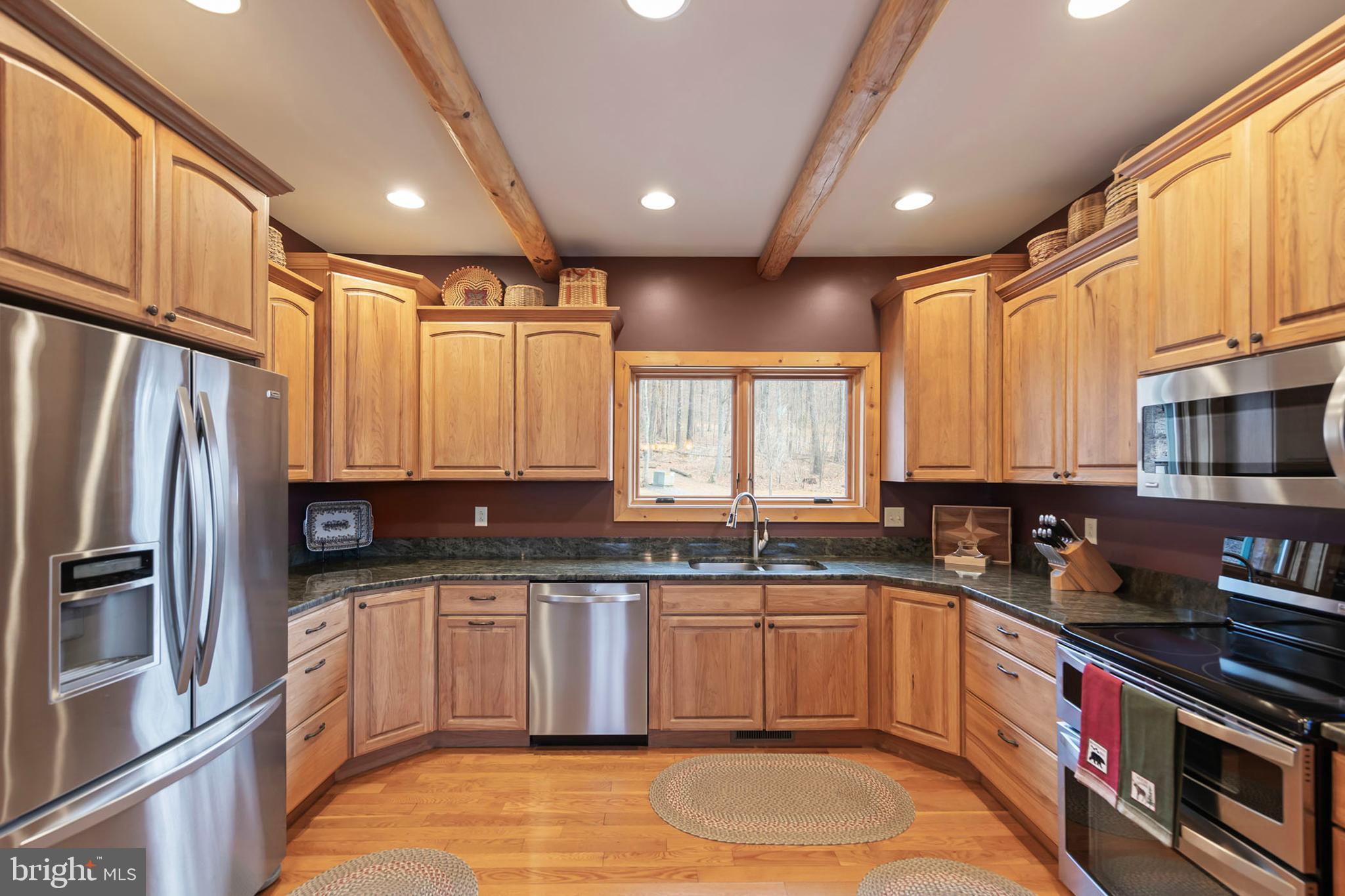 181 Signal Ridge Lane Winchester, VA 22603 - Photo 4 of 70 a kitchen with stainless steel appliances granite countertop a sink a stove a refrigerator cabinets and a window