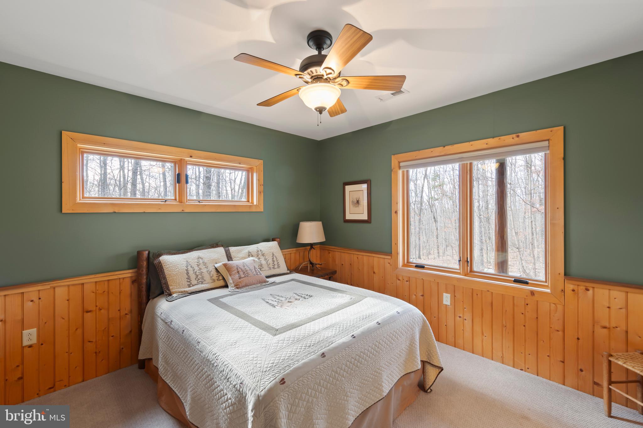 181 Signal Ridge Lane Winchester, VA 22603 - Photo 43 of 70 a bedroom with a large bed and a chandelier