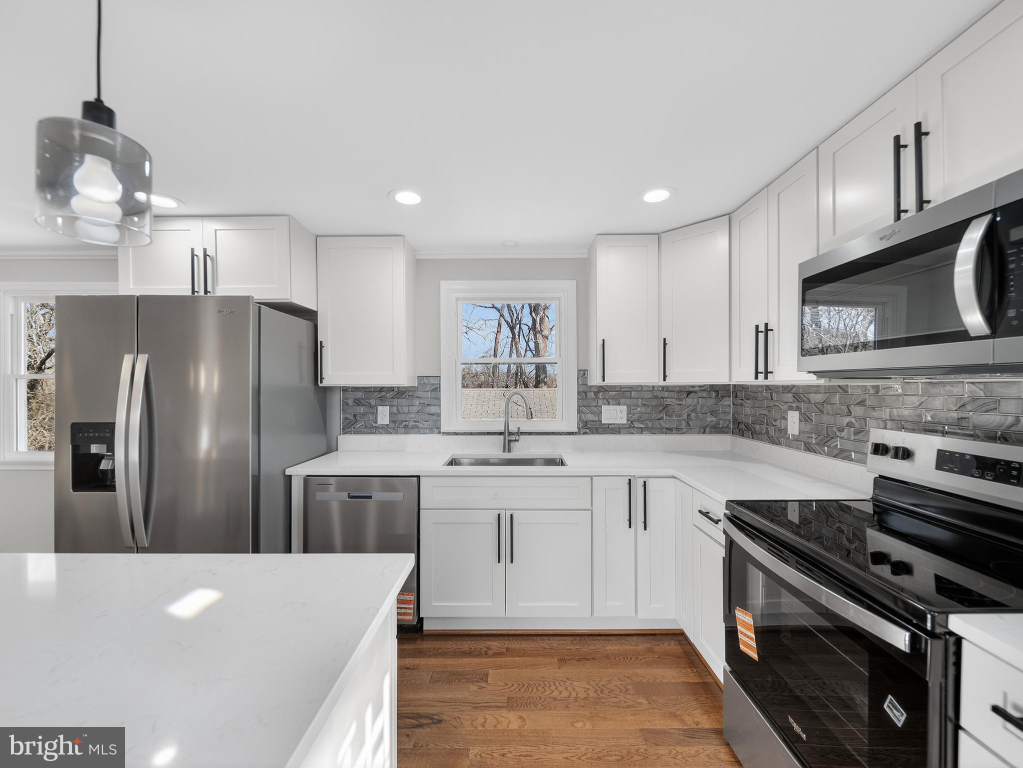 24676 Old 3 Notch Road Hollywood, MD 20636 - Photo 11 of 45 a kitchen with stainless steel appliances granite countertop a sink a stove a refrigerator cabinets and chairs