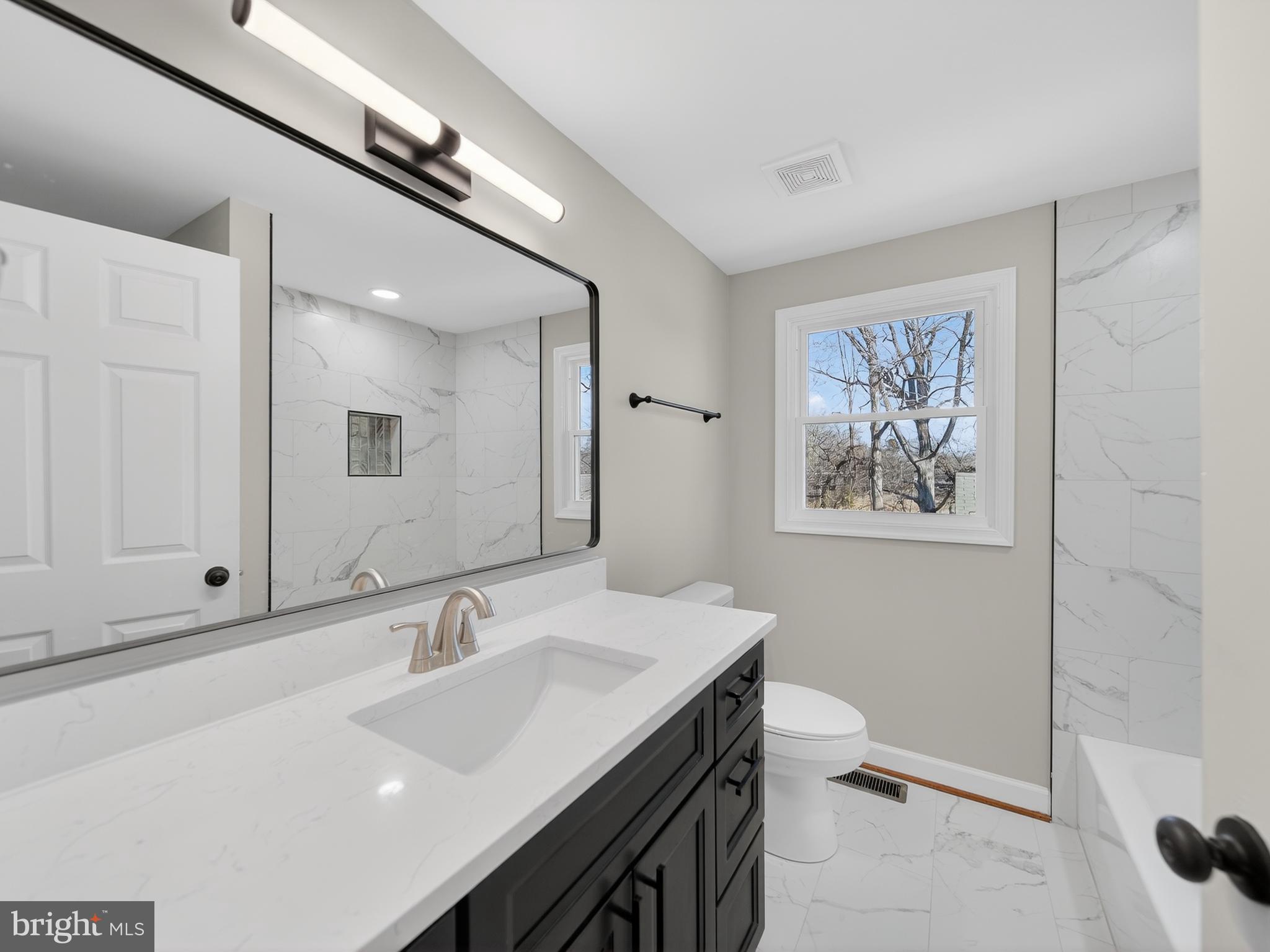 24676 Old 3 Notch Road Hollywood, MD 20636 - Photo 14 of 45 a bathroom with a sink and a mirror