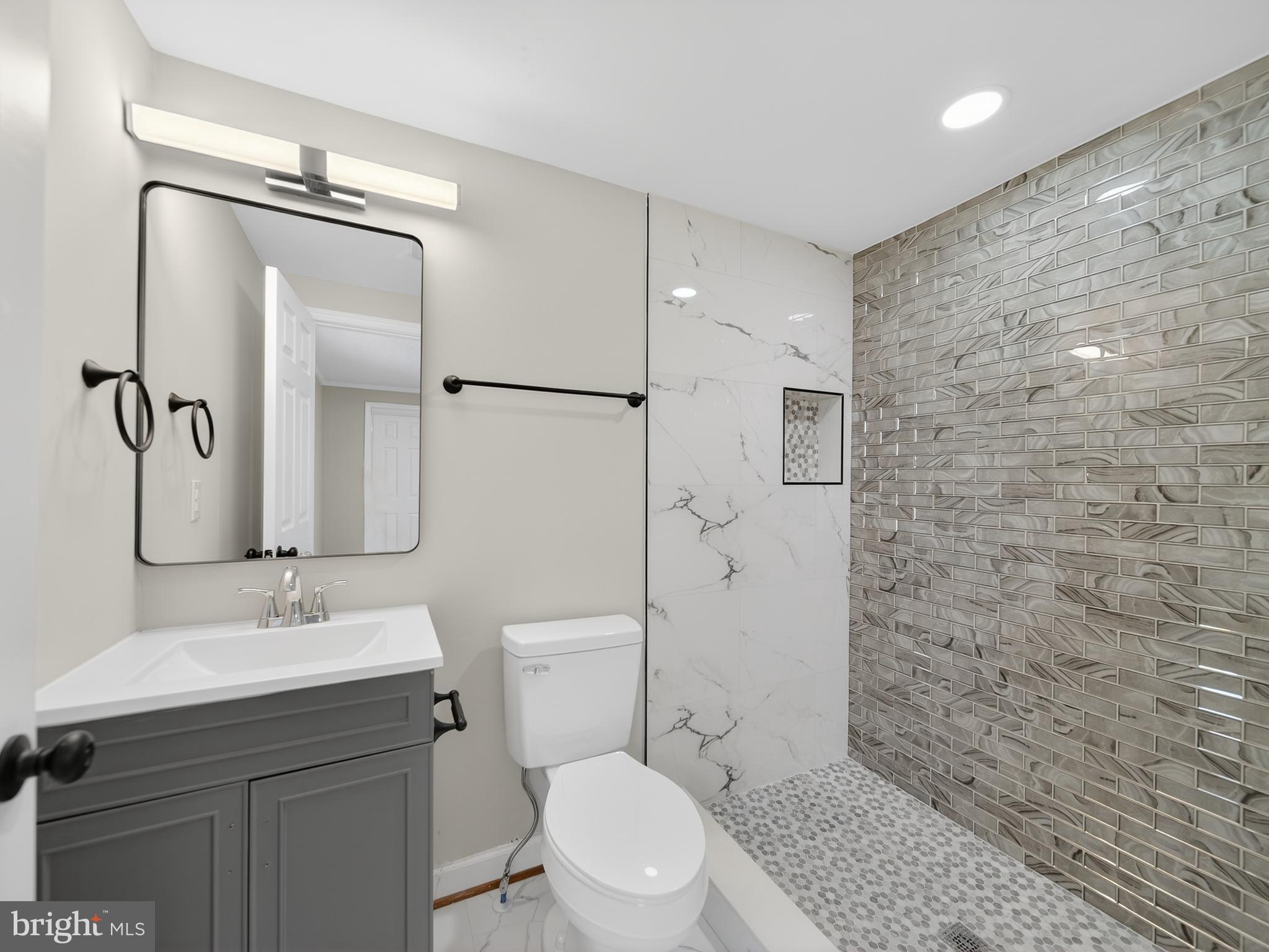 24676 Old 3 Notch Road Hollywood, MD 20636 - Photo 26 of 45 a bathroom with a sink a toilet and shower