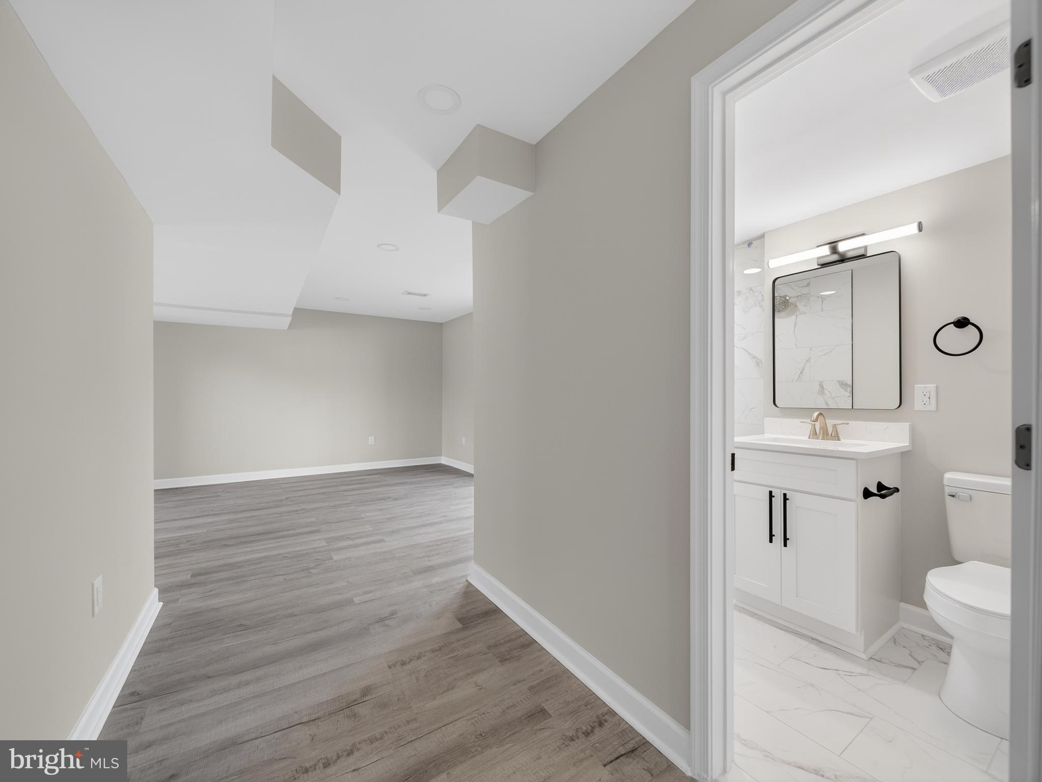 24676 Old 3 Notch Road Hollywood, MD 20636 - Photo 31 of 45 a bathroom with a sink a toilet and shower