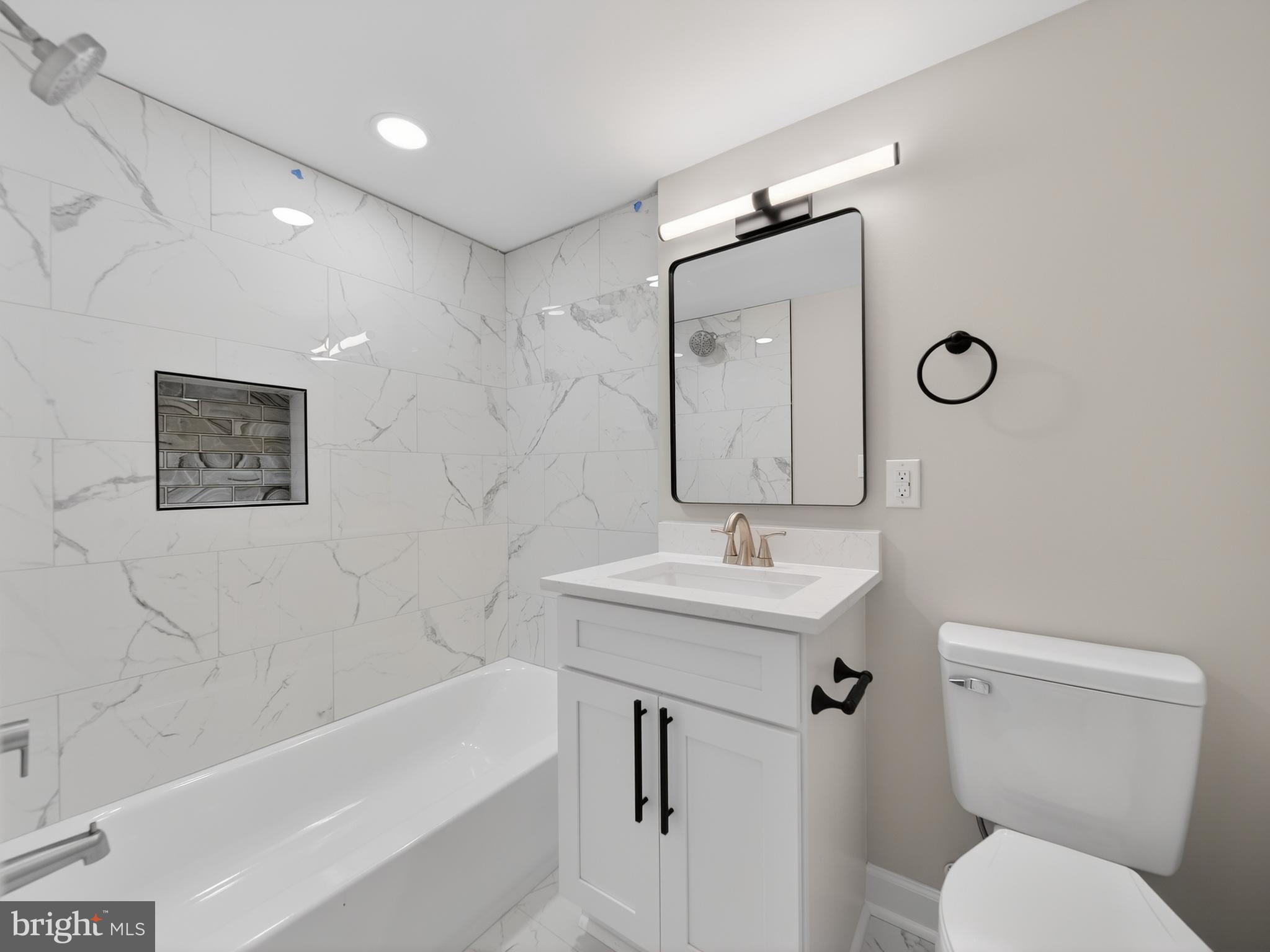 24676 Old 3 Notch Road Hollywood, MD 20636 - Photo 32 of 45 a bathroom with a toilet a sink and mirror