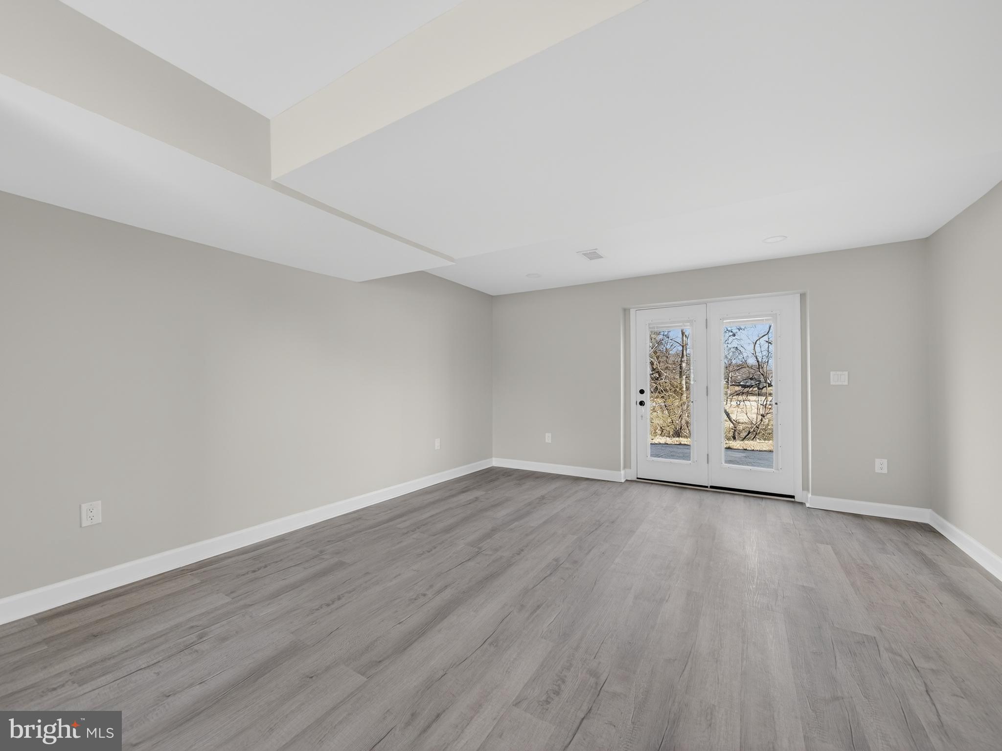 24676 Old 3 Notch Road Hollywood, MD 20636 - Photo 33 of 45 a view of an empty room with wooden floor and a window