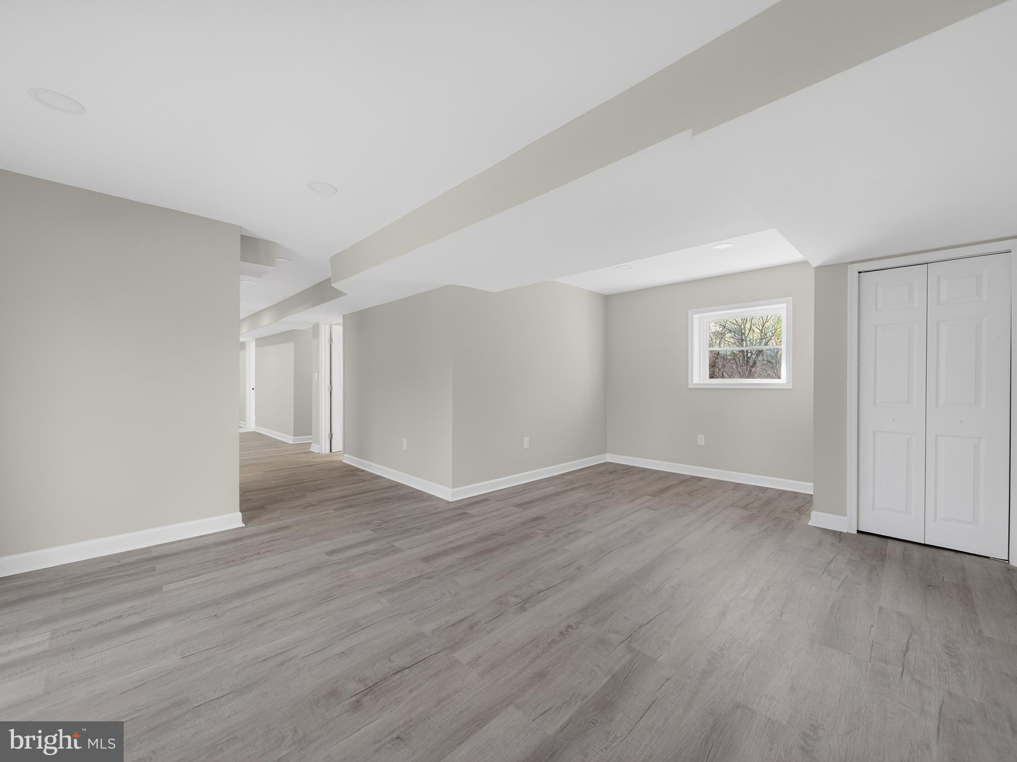 24676 Old 3 Notch Road Hollywood, MD 20636 - Photo 35 of 45 a view of an empty room with wooden floor and a window