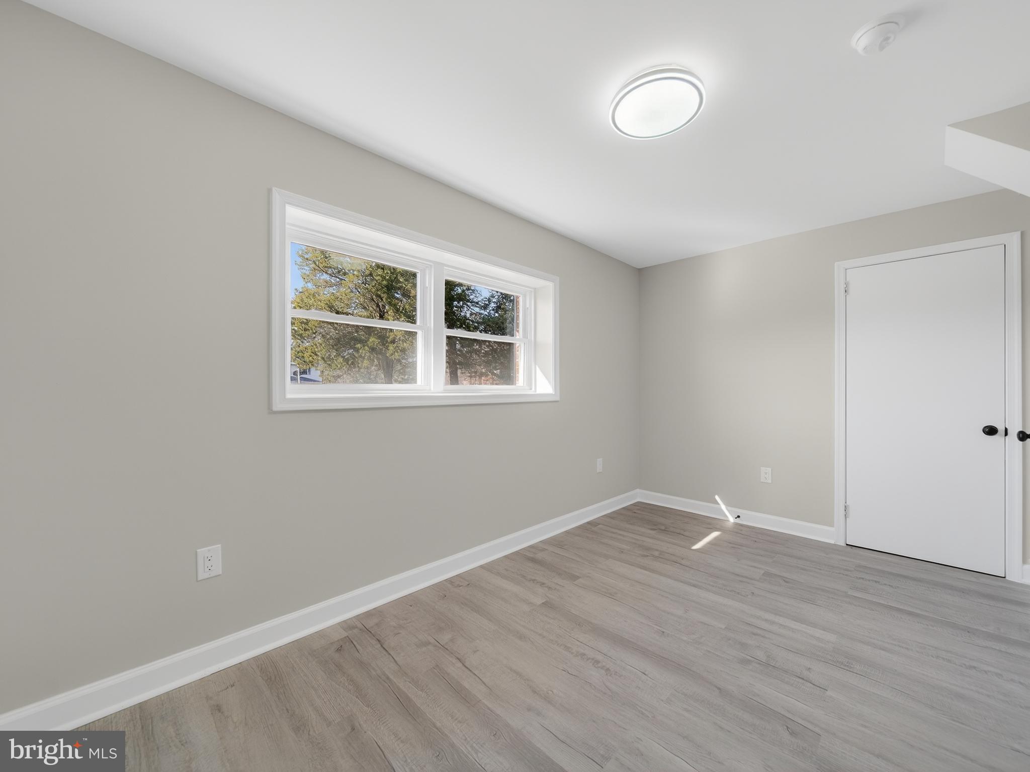 24676 Old 3 Notch Road Hollywood, MD 20636 - Photo 38 of 45 an empty room with wooden floor and windows