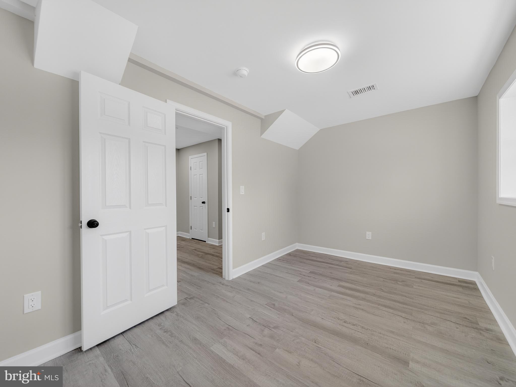 24676 Old 3 Notch Road Hollywood, MD 20636 - Photo 40 of 45 a view of an empty room with wooden floor