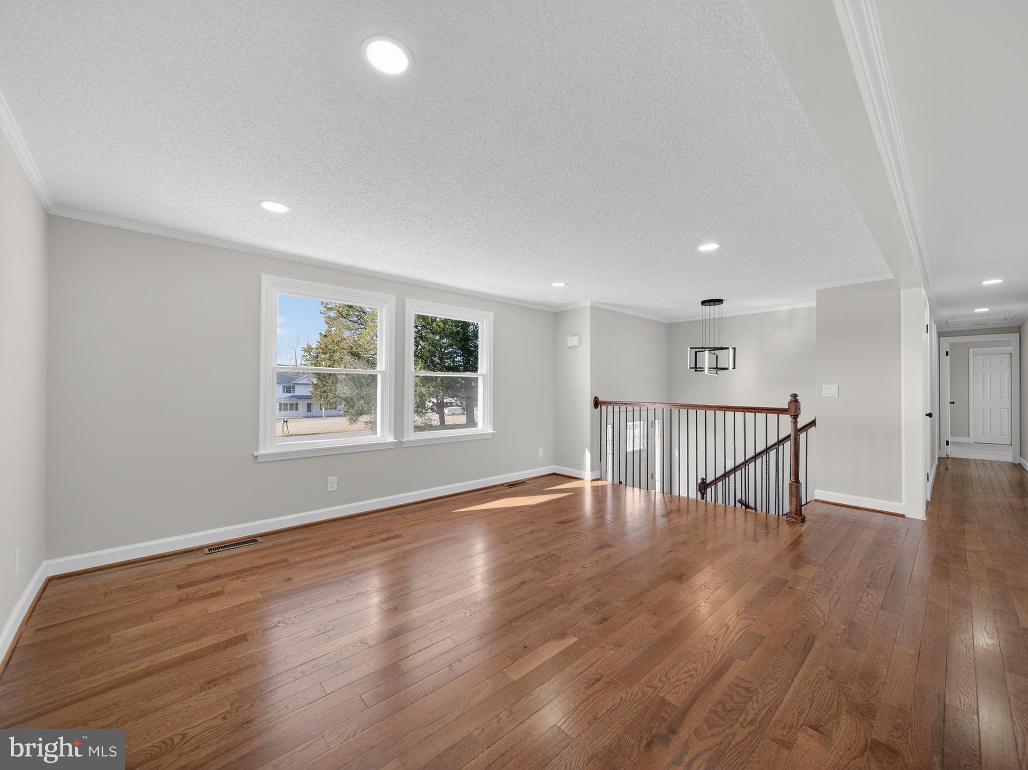 24676 Old 3 Notch Road Hollywood, MD 20636 - Photo 5 of 45 a view of an empty room with wooden floor and a window