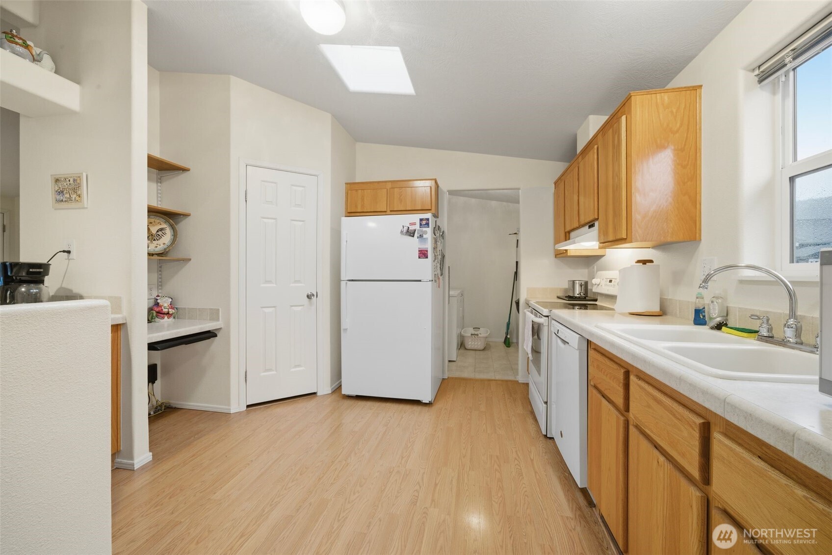 1913 7th Street Sedro-Woolley, WA 98284 - Photo 8 of 28 a kitchen with a refrigerator a stove a sink dishwasher and wooden cabinets with wooden floor
