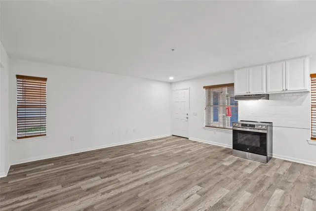 a view of a kitchen with a stove cabinets and wooden floor