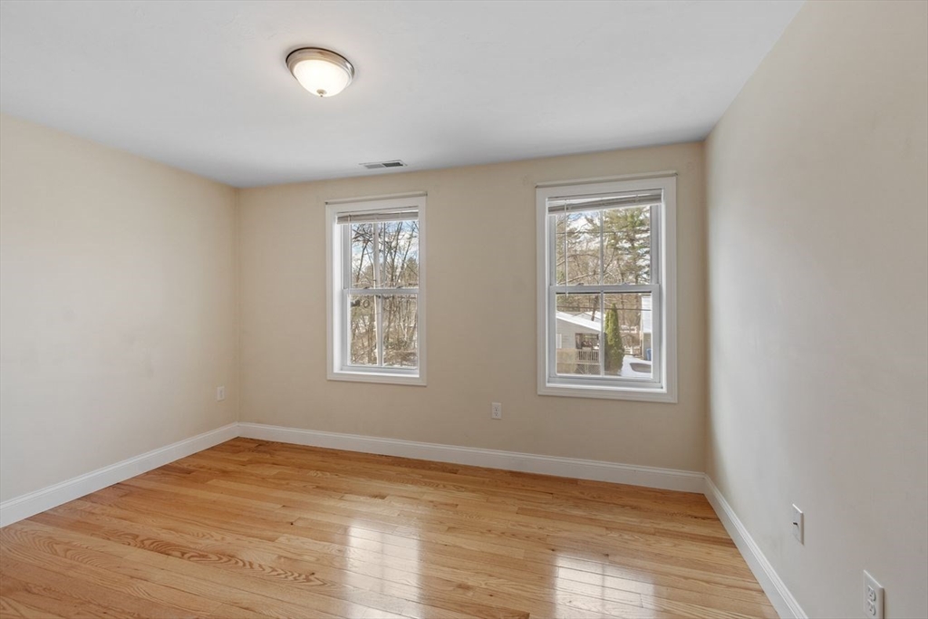 51 Valley Road Tewksbury, MA 01876 - Photo 12 of 17 a view of an empty room with wooden floor and a window