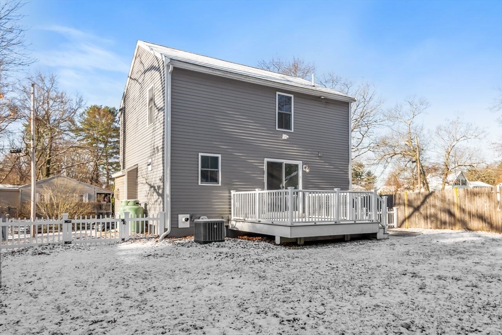 51 Valley Road Tewksbury, MA 01876 - Photo 15 of 17 a view of a house with a wooden fence