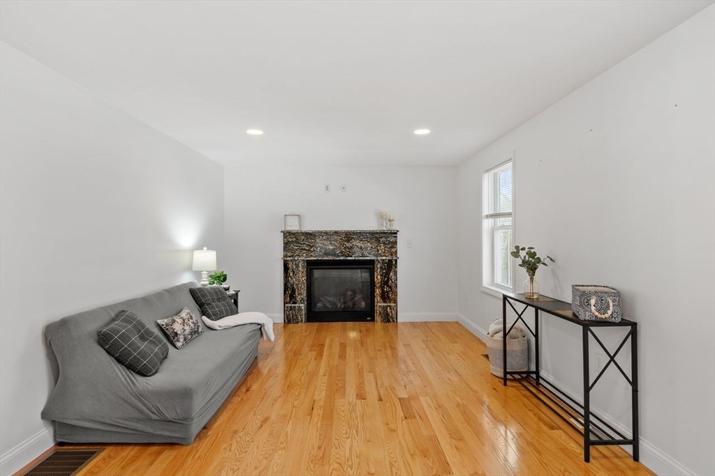 51 Valley Road Tewksbury, MA 01876 - Photo 2 of 17 a living room with furniture and a fireplace