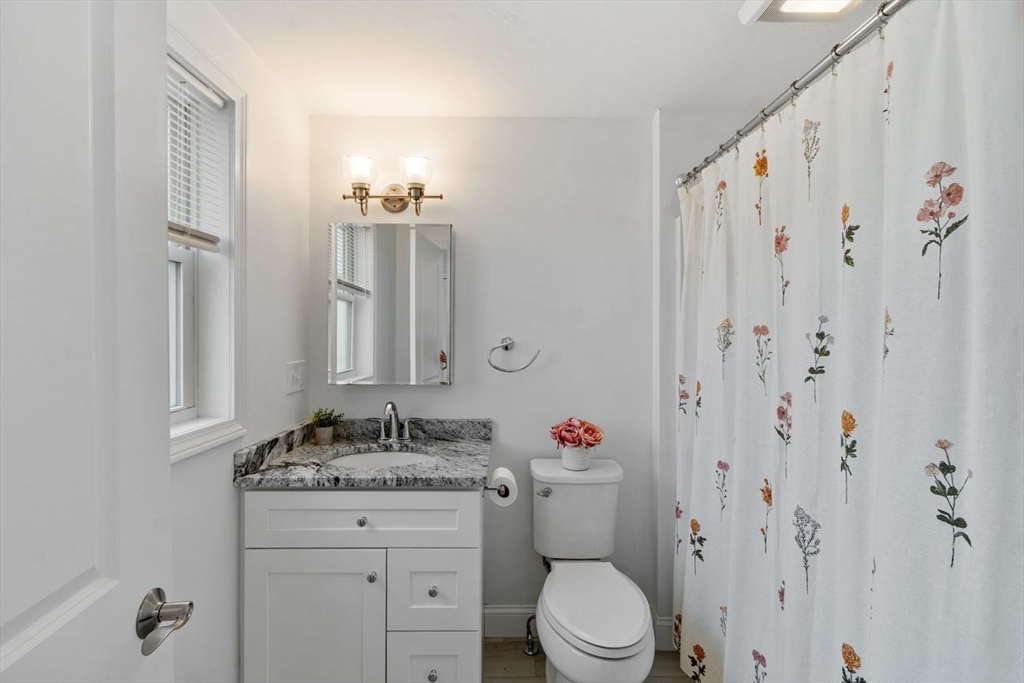51 Valley Road Tewksbury, MA 01876 - Photo 5 of 17 a bathroom with a granite countertop sink and a mirror