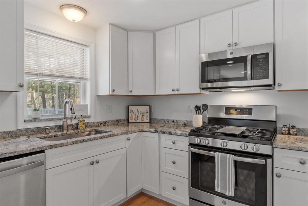51 Valley Road Tewksbury, MA 01876 - Photo 8 of 17 a kitchen with granite countertop white cabinets stainless steel appliances and a sink