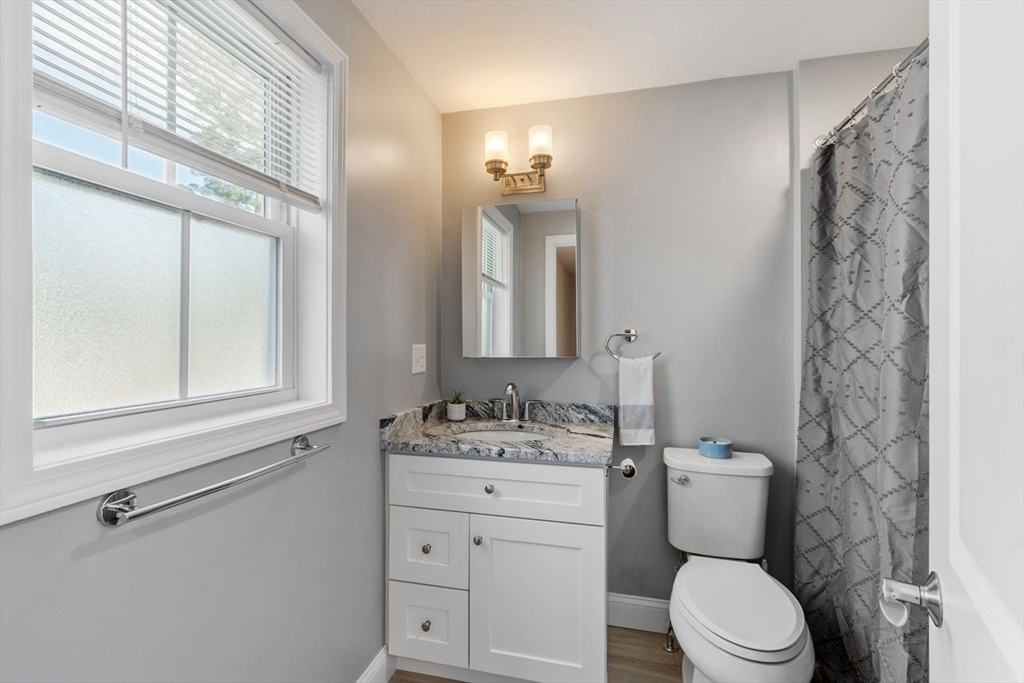 51 Valley Road Tewksbury, MA 01876 - Photo 9 of 17 a bathroom with a sink a toilet and a mirror