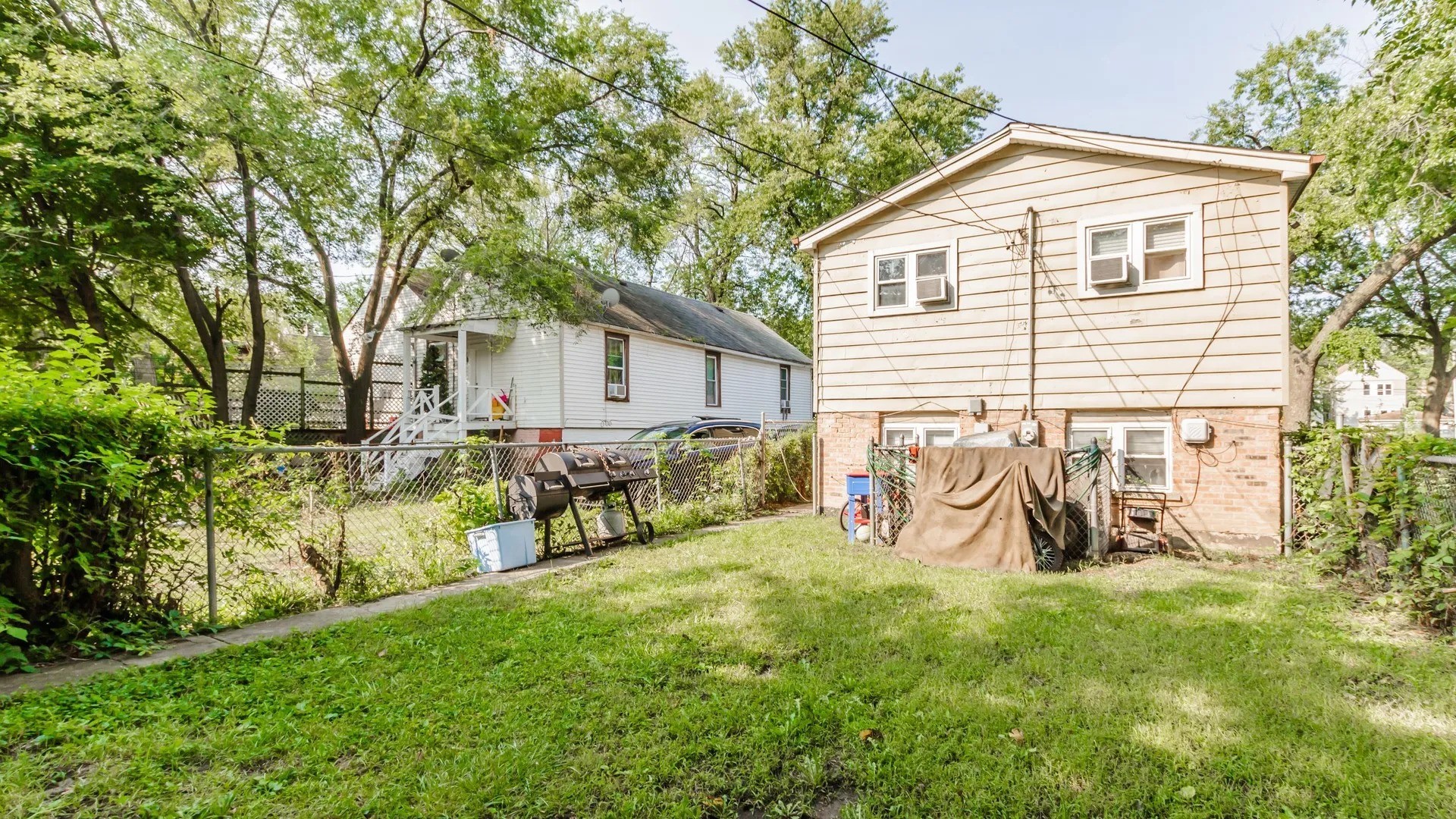 5141 South Carpenter Street Chicago, IL 60609 - Photo 19 of 23 a view of backyard with a table and chairs and a large tree
