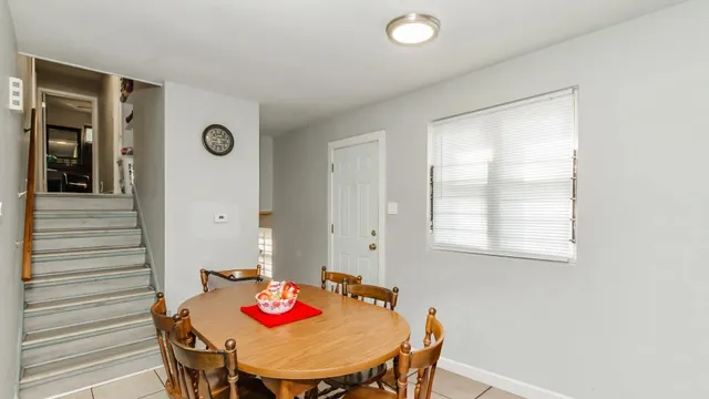 a view of a dining room with furniture and window