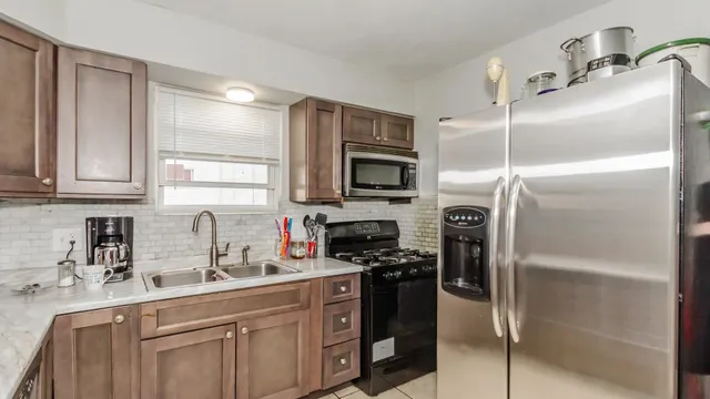 a kitchen with a refrigerator and a sink
