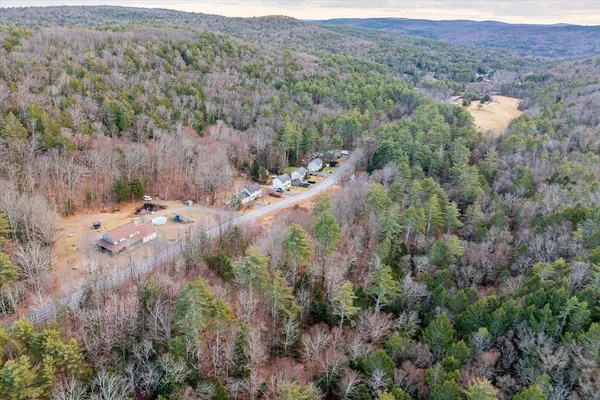 an aerial view of house with yard and mountain view