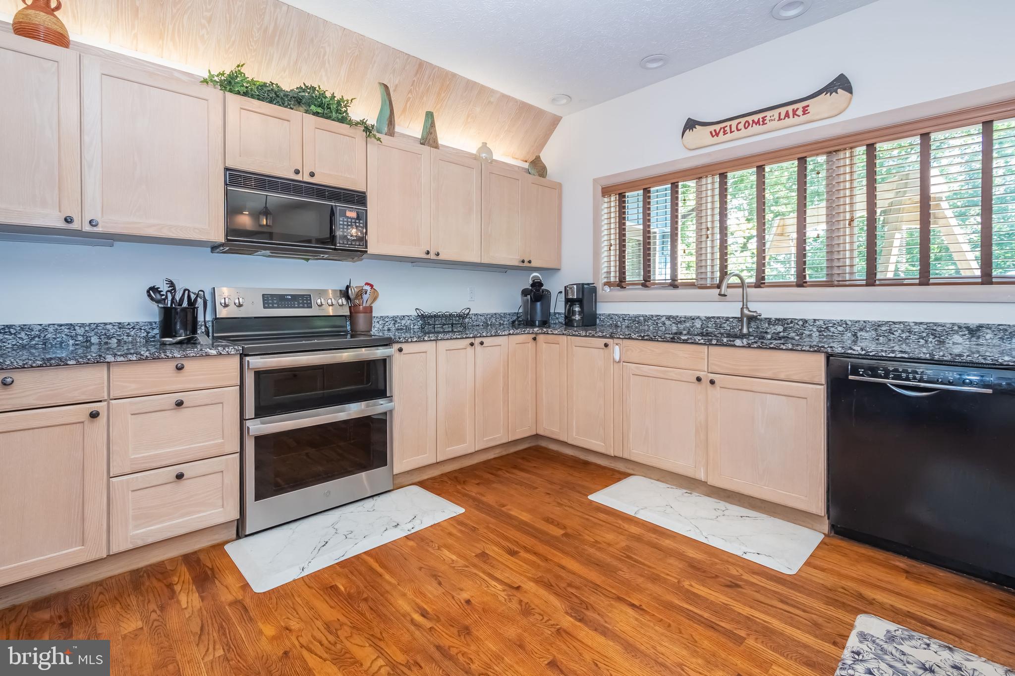 2345 Marsh Hill Road McHenry, MD 21541 - Photo 11 of 77 a kitchen with stainless steel appliances granite countertop a stove a sink and white cabinets