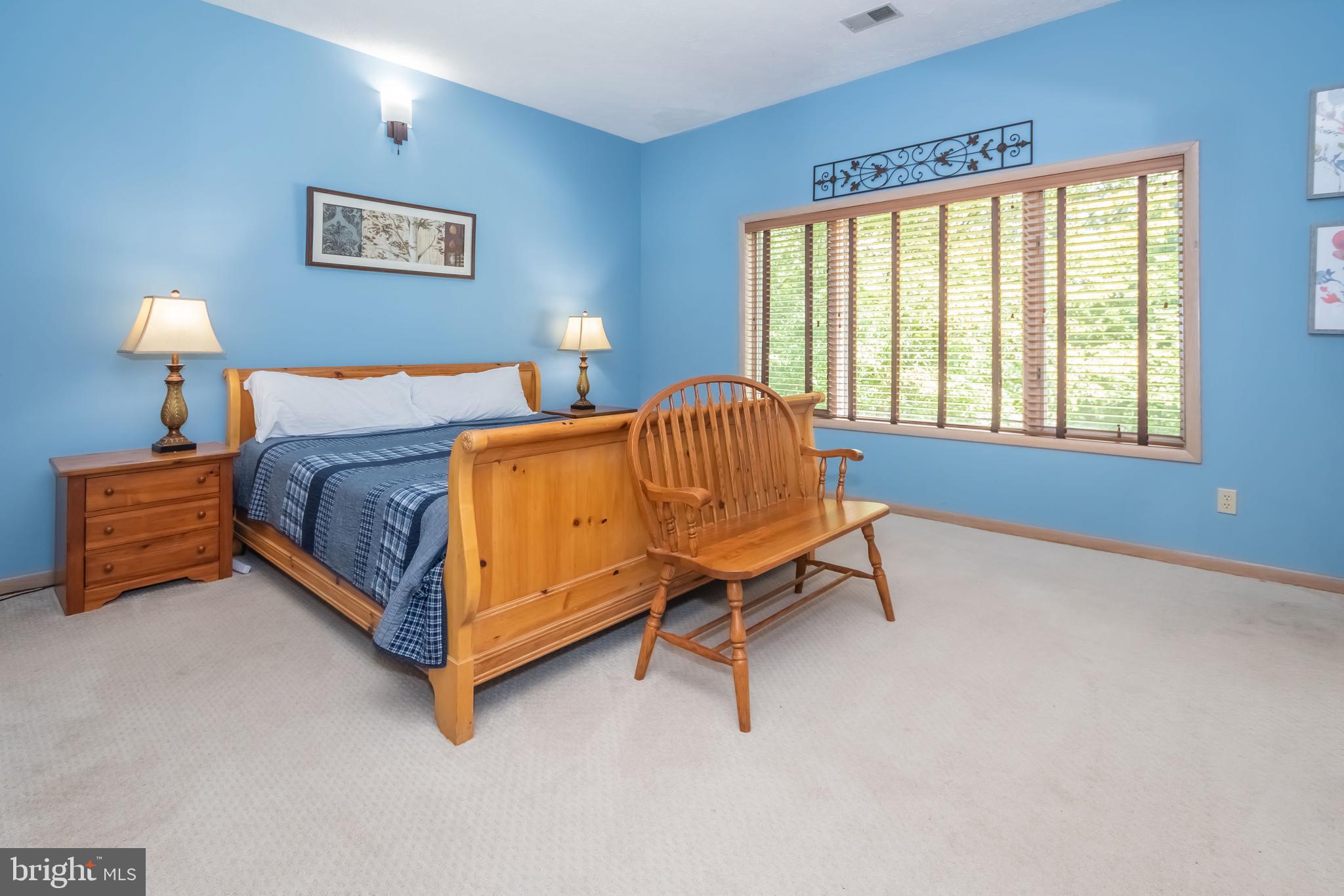 2345 Marsh Hill Road McHenry, MD 21541 - Photo 39 of 77 a bedroom with a bed and a lamp on table