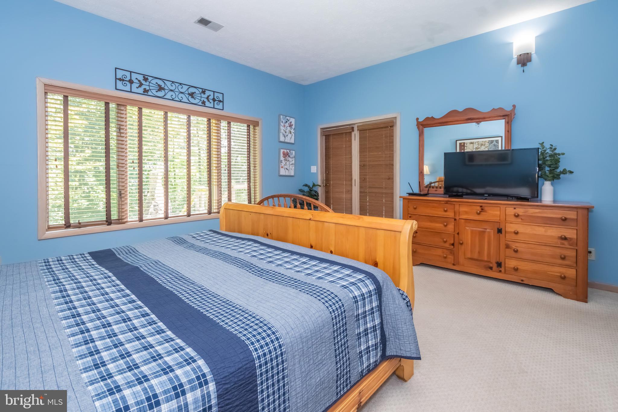 2345 Marsh Hill Road McHenry, MD 21541 - Photo 40 of 77 a bedroom with a bed and flat tv screen on the dresser