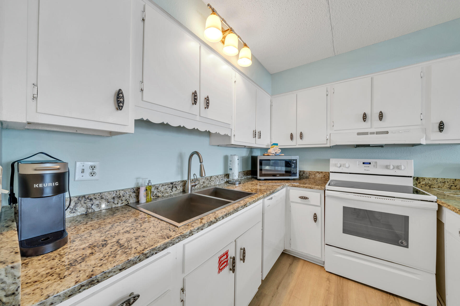 676 Santa Rosa Boulevard, Unit 4D Fort Walton Beach, FL 32548 - Photo 15 of 30 a kitchen with granite countertop white cabinets and white appliances