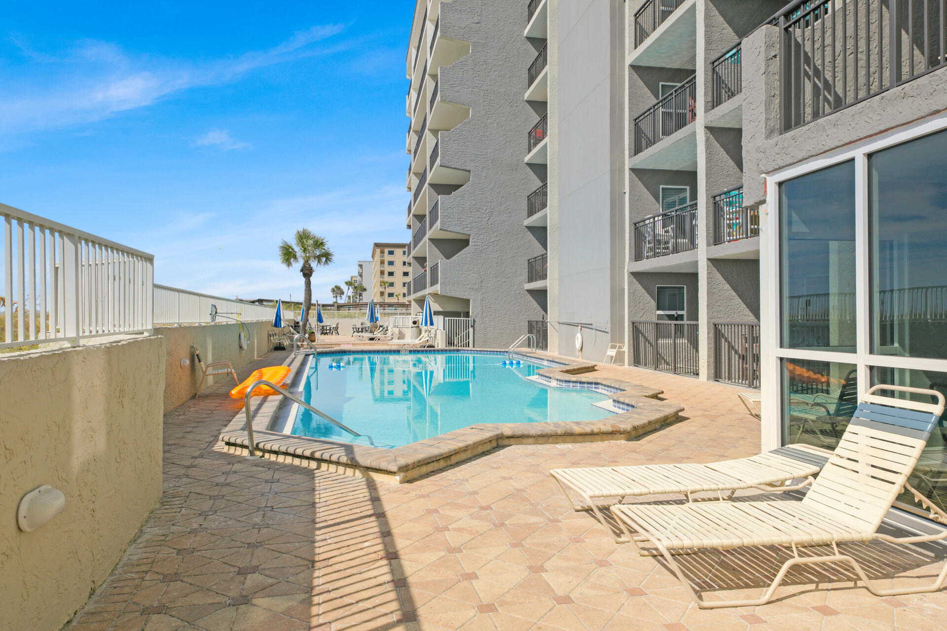 676 Santa Rosa Boulevard, Unit 4D Fort Walton Beach, FL 32548 - Photo 2 of 30 a view of a swimming pool with a lounge chairs