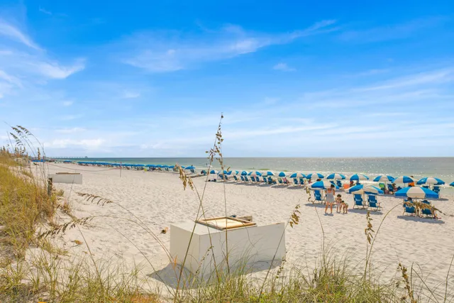 a spacious bedroom with a bed and a lamp