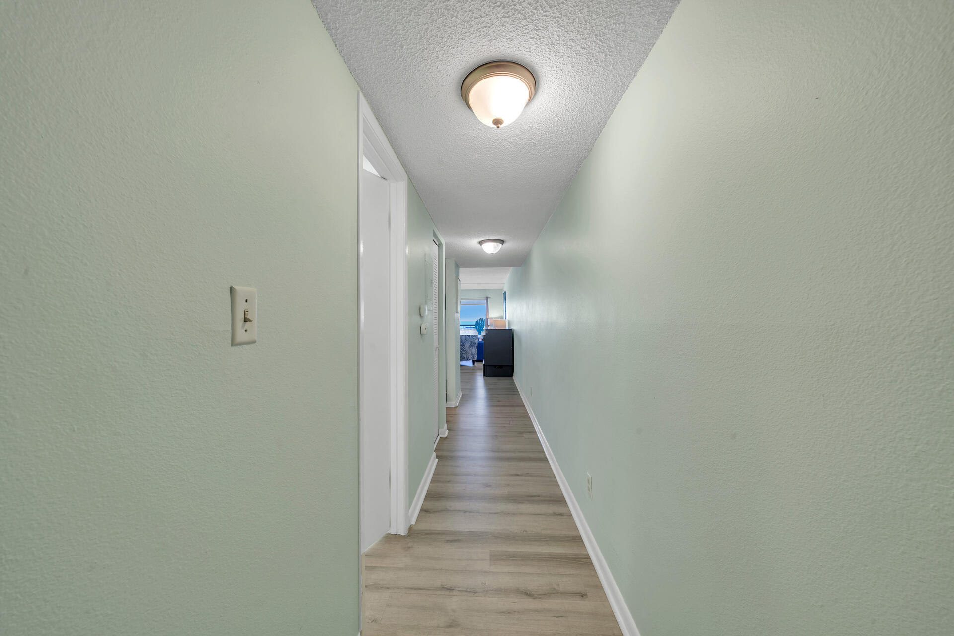 676 Santa Rosa Boulevard, Unit 4D Fort Walton Beach, FL 32548 - Photo 8 of 30 a view of a hallway with wooden floor and stairs