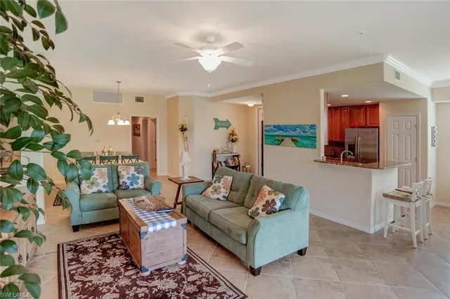 a living room with furniture and a potted plant